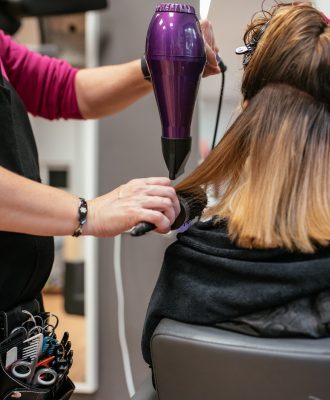 Hairdresser drying woman's hair
