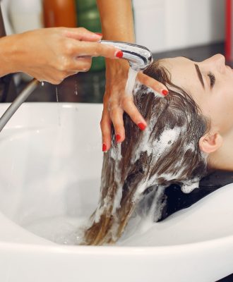 Woman washing head in a hairsalon